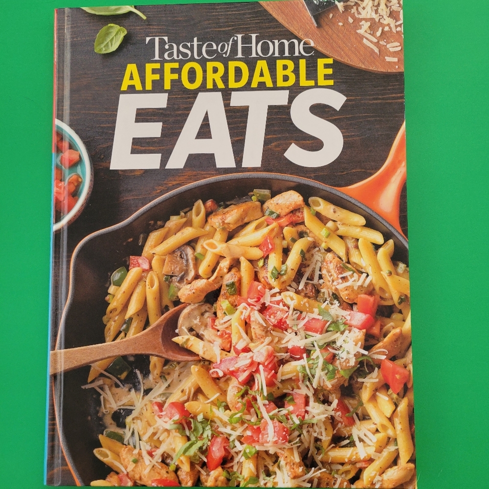 Taste of Home Affordable Eats Cookbook with Yellow and Orange Highlights